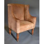 A Beige Leather Upholstered Wingback Armchair by Kathleen Spiegelman with turned tapering legs and