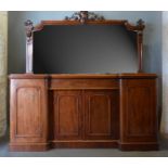 A Victorian Mahogany Sideboard, the shaped mirrored back with scroll carved cresting, the lower