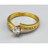 A 18ct Yellow Gold Solitaire Diamond Ring with central diamond within a crossover setting and