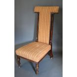 A William IV Rosewood Pre Dieu Chair, the upholstered back and seat raised upon turned reeded legs