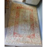 A Turkish Woollen Rug with Five Central Medallions upon a cream and terracotta ground with