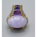 A 14ct Gold Amethyst and Diamond Set Pendant with a large Cabochon Amethyst surrounded by diamonds