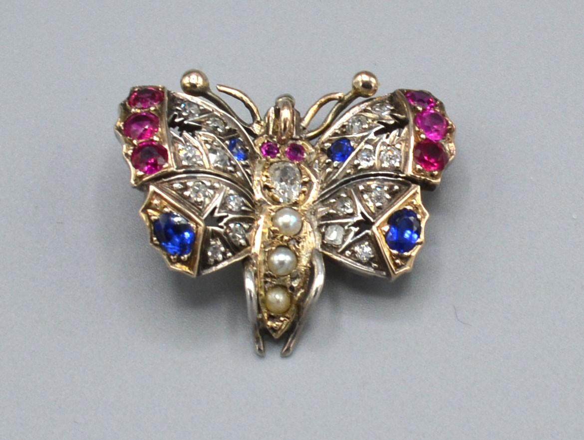 A Yellow Metal Brooch in the Form of a Butterfly set with diamonds, rubies, sapphires and pearls,