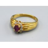 A tested 18ct Yellow Gold Ruby and Diamond Ring set with central ruby surrounded by diamonds