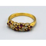 A 18ct Yellow Gold Diamond and Ruby Ring set with three rows of rubies interspersed with diamonds,
