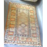 A Turkish Woollen Rug with an all over design upon a pale cream and terracotta ground within