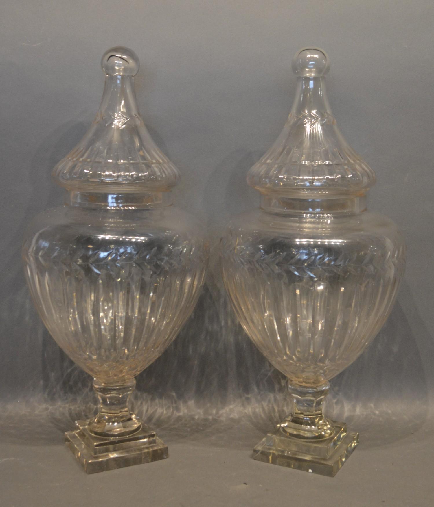 A Pair of Cut Glass Covered Vases of Shaped Form with ribbed decoration and square stepped bases