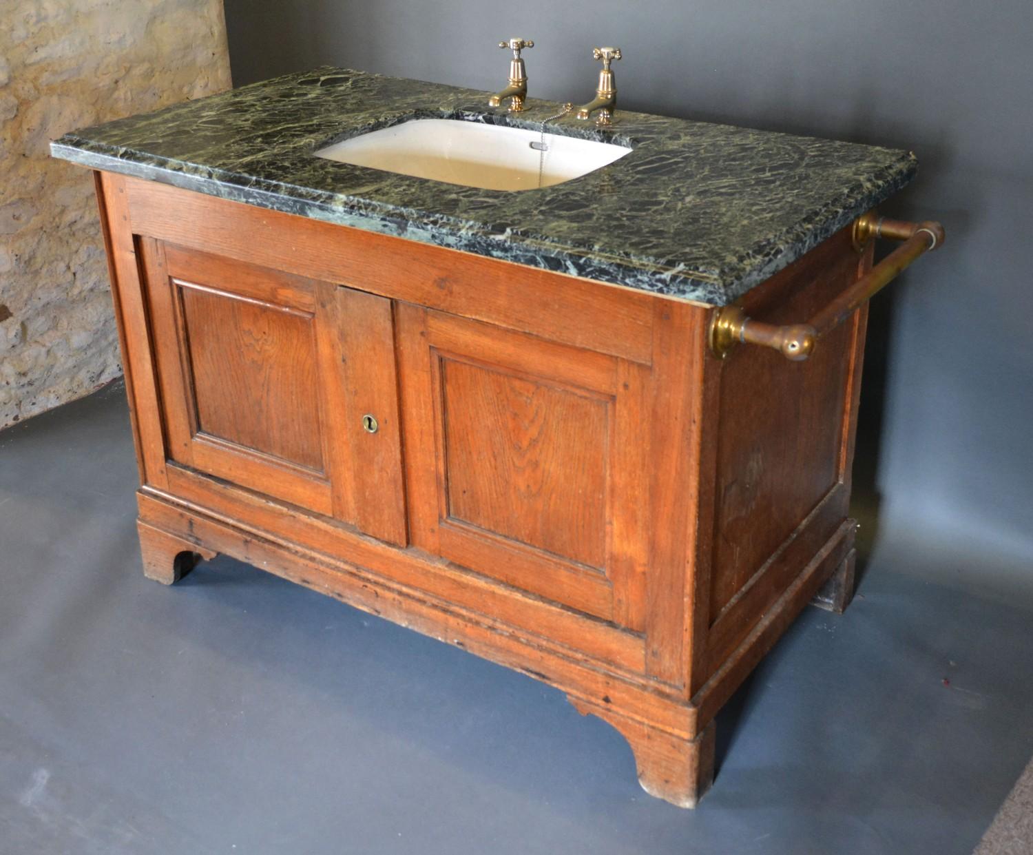 A Large Sink with a variegated marble top upon a 19th century oak base with two panel doors raised - Image 2 of 2