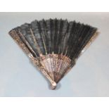 A Late 19th Century French Lace Fan, mother of pearl sticks with foliate carving, black Chantilly