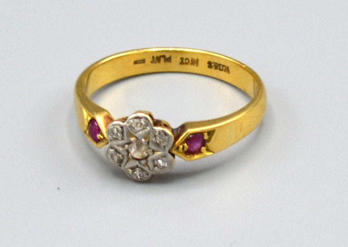 A 18ct Yellow Gold Diamond Cluster Ring set with seven diamonds within a cluster and with ruby