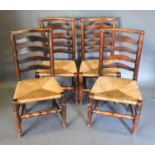 A Set of Four Early 19th Century Elm Ladder Backed Chairs with rush seats raised upon turned