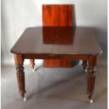 A Victorian Mahogany Pull-out Extending Dining Table, the moulded top above a plain frieze, raised