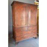 A 19th Century Mahogany Linen Press the moulded cornice above two panelled doors enclosing sliding