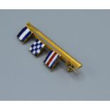 A 18ct Gold Tie Pin Enamel decorated with three flags, 4cm long, 5.4 grams