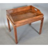A Mahogany Butlers Tray of shaped form the stand with square chamfered legs 62cm wide, 47cm deep,