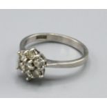 A Platinum Diamond Cluster Ring set with seven diamonds within a pierced setting, Size N, 4.5 grams