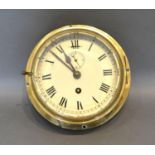 A Brass Cased Bulk Head Clock, the dial with roman numerals and single train movement 17cm diameter