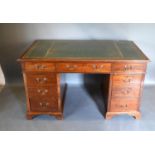 A Edwardian Mahogany Twin Pedestal Desk, the green tooled leather inset top on nine drawers with