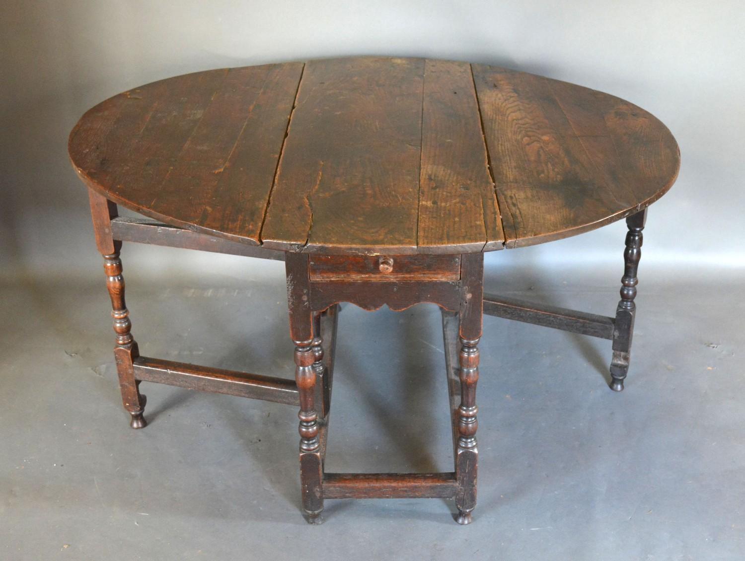 A George III Oak Oval Gate Legged Dining Table with a frieze drawer raised upon turned legs with - Image 2 of 2
