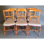 A Set of Six Victorian Mahogany Chairs with rail backs, upholstered seats, turned legs with outswept