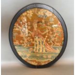 A Early 19th Century Oval Wool Work depicting a figure amongst foliage 43cm x 36cm