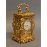 A Miniature Brass Cased Carriage Clock of Rococo form the enamel dial with roman numerals, with