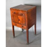 A 19th Century Mahogany Washstand with a double hinged top above a simulated drawer with cupboards