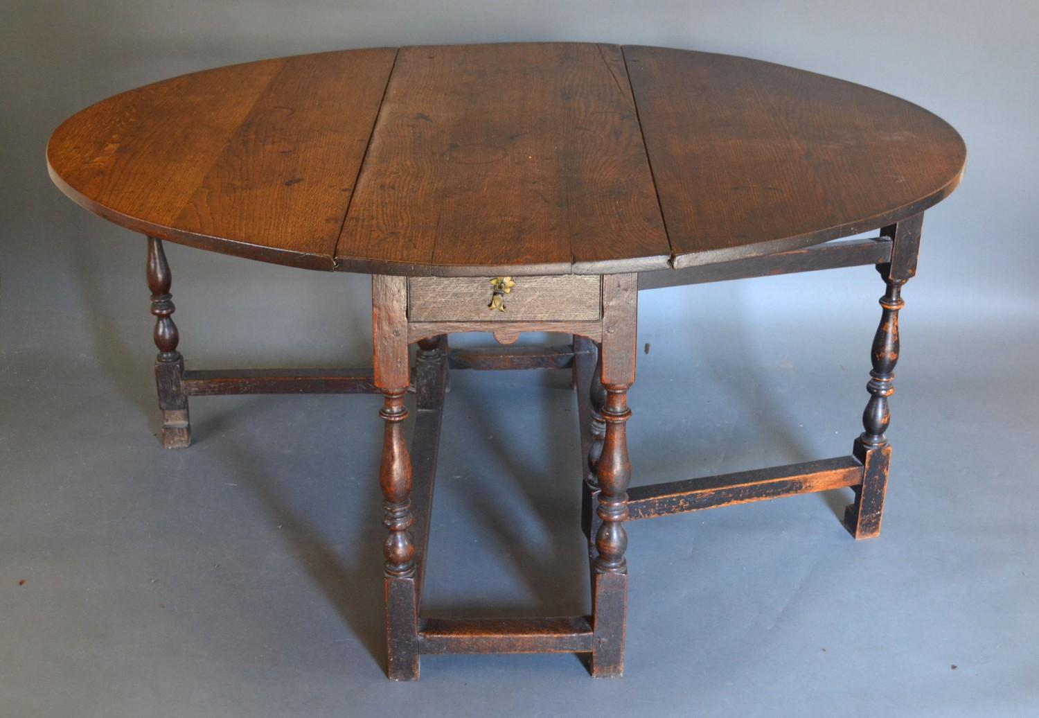 A George III Oak Oval Gateleg Dining Table with a frieze drawers above turned supports with - Image 2 of 2