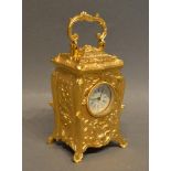 A Miniature Brass Cased Carriage Clock of Rococo Form, the dial roman numerals and shaped handle 7cm