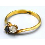 An 18ct. Gold Sapphire and Diamond Crossover Ring, 3.5 gms. ring size Q