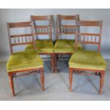 A Set of Four Late Victorian Walnut Dining Chairs by James Shoolbred each with a carved bar and