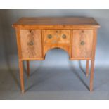 A late 19th/early 20th Century Sideboard with a central drawer flanked by cupboard doors raised upon