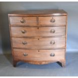 A 19th Century Mahogany Bow-fronted Desk of two short and three long drawers with oval brass handles