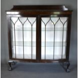 An Early 20th Century Mahogany bow-fronted display cabinet with a low galleried top above two
