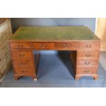 A 20th Century Mahogany Twin Pedestal Desk with tooled leather inset top above nine drawers with