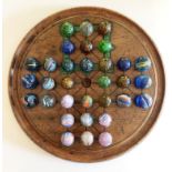 A Collection of Victorian Marbles complete with Solitaire board and an early Ludo box