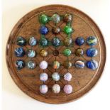 A Collection of Victorian Marbles complete with Solitaire board and an early Ludo box