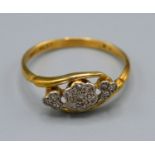 A 18ct Yellow Gold Diamond Ring set with three clusters of diamonds within a crossover setting, size