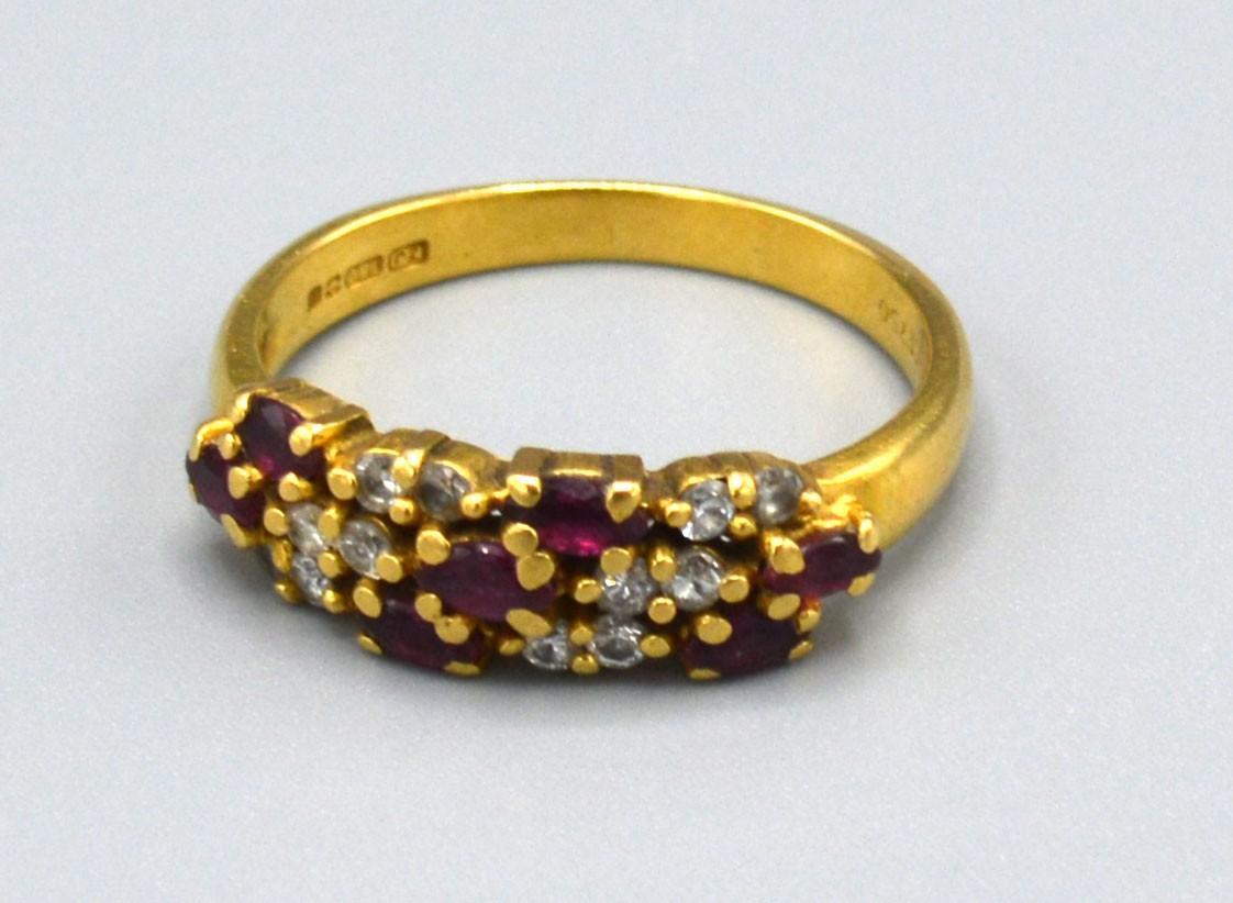 A 18ct Yellow Gold Diamond and Ruby Ring set with three rows of rubies interspersed with diamonds,