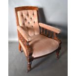 A Victorian Mahogany Drawing Room Armchair with button upholstered back above a stuff over seat