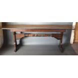 An Oak Long Table, the single plank top with iron banding above twin end supports with turned centre