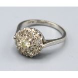 An 18ct. Gold Diamond Cluster Ring set with many diamonds within a pierced setting, 3.5 gms. ring