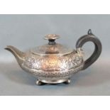 A George III Silver Small Teapot of circular embossed form with ebonised handle, London 1816,