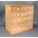 A Pine Straight Front Chest of two short and three long drawers with ceramic handles raised upon a