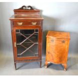 An Edwardian Mahogany Music Cabinet with an astragal glazed door enclosing shelves together with