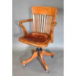 A Victorian Mahogany Revolving Office Armchair with outswept legs