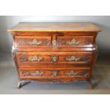 An 18th Century French Oak Commode, the moulded top above two short and two long drawers with