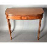 A 19th Century Mahogany Tea Table, the reeded hinged top above an inlaid frieze raised upon spiral