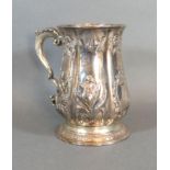 A George II Silver Presentation Mug with Foliate Embossing and Shaped Handle and bearing inscription