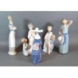 A Lladro Group 'Boy and Girl Holding a Candle' together with four other Lladro figures and a